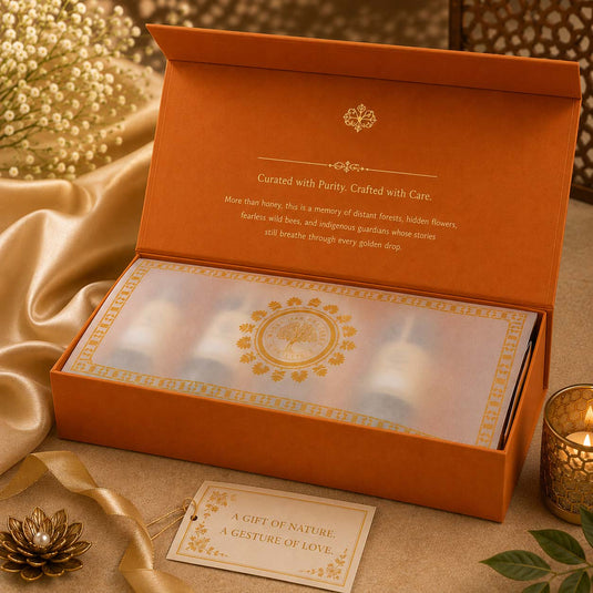 Elegant luxury honey gift hamper in premium orange presentation box with refined packaging, handcrafted details, and artisanal wellness products for gifting.