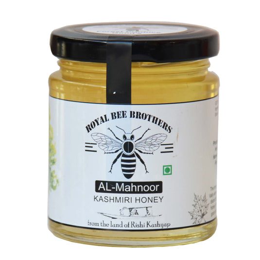 Close-up of milky white Kashmiri honey dripping from comb harvested from Sulai flower nectar.