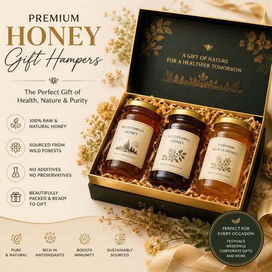 Luxury premium honey gift hamper featuring three glass jars of wild forest honey in an elegant gold-accented gift box, set on a soft beige botanical background with floral decorations. 