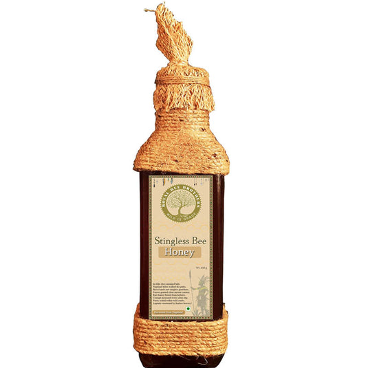 Bottle of Stingless Bee Honey with a decorative top on a white background